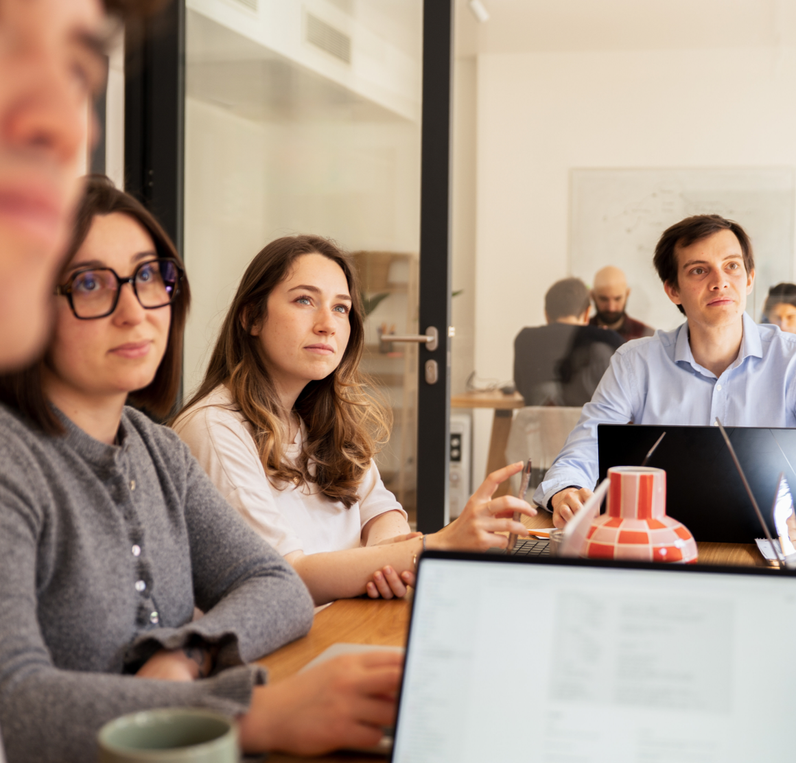 Three Galadrim employees in a work meeting in front of their computers