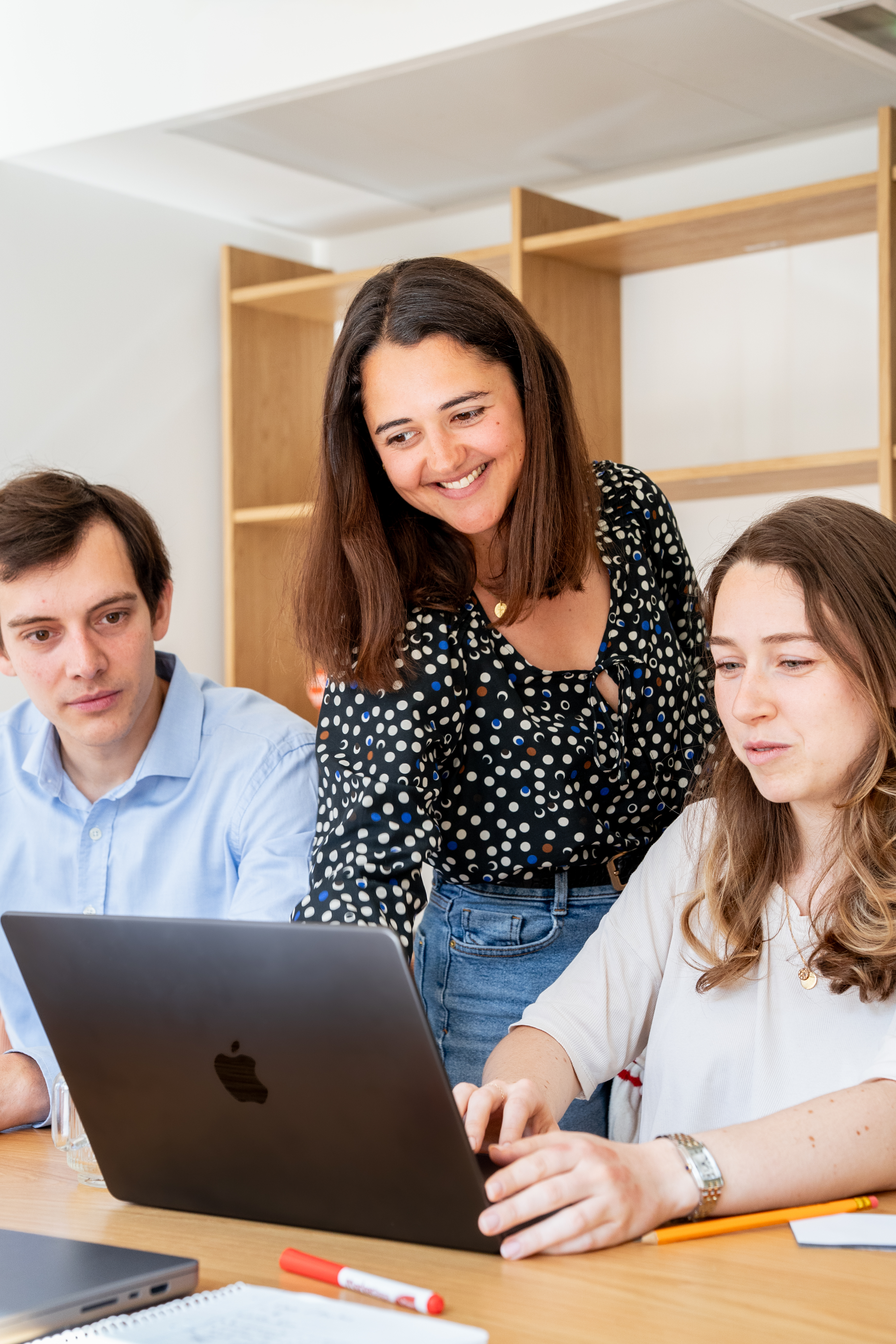 Three Galadrimers gathered around a laptop